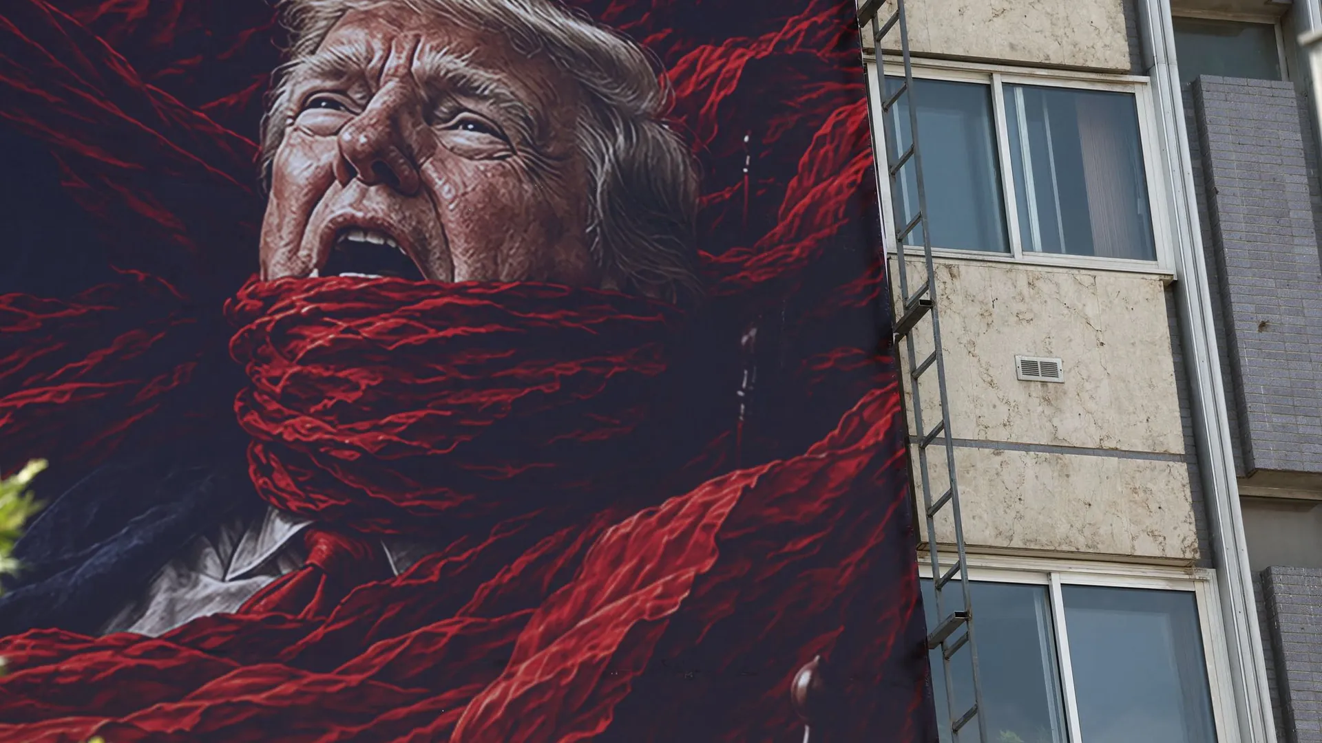 A large billboard in central Tehran shows the US president caught up in his own politics. A large billboard in central Tehran shows the US president caught up in his own politics.