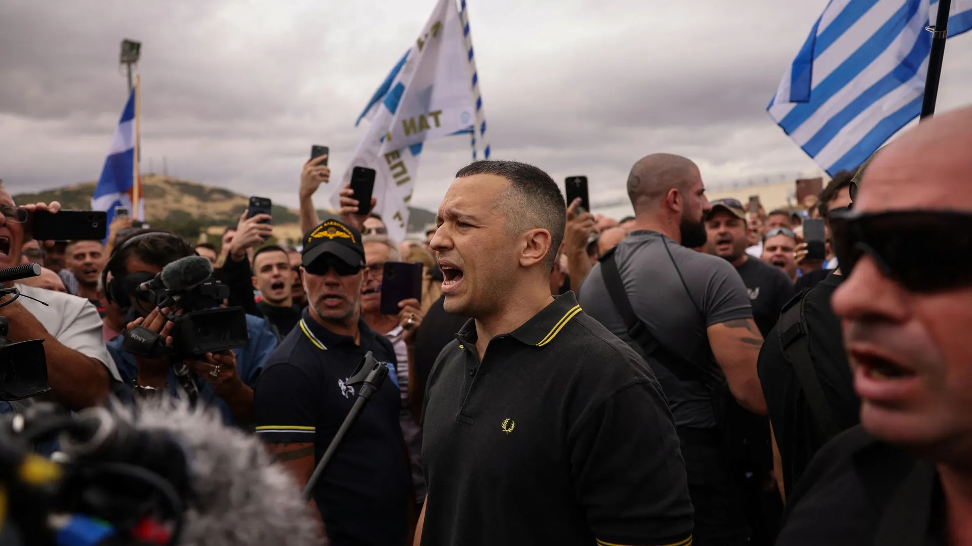 Ilias Kasidiaris with supporters in front of a prison in Athens after his release from prison. Ilias Kasidiaris with supporters in front of a prison in Athens after his release from prison.